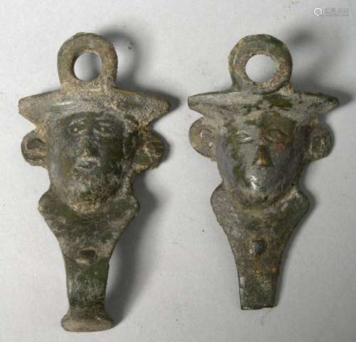 A pair of bronze cauldron handles representing the…