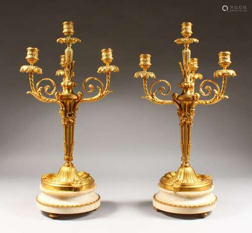 A SUPERB PAIR OF LOUIS XVI ORMOLU AND WHITE MARBLE FOUR LIGHT CANDELABRA, with three scrolling