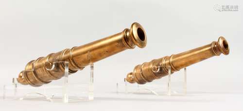 A VERY GOOD PAIR OF BRONZE CANNONS on Perspex bases. 13ins long.