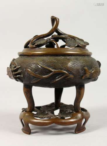 A CHINESE CIRCULAR BRONZE CENSER ON A STAND. 7ins high.