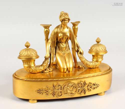 A SUPERB FRENCH EMPIRE ORMOLU OVAL INKSTAND, the top with a classical female figure holding a pair