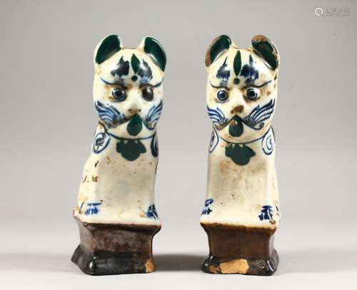 A PAIR OF POTTERY CAT CANDLESTICKS. 7.5ins high.