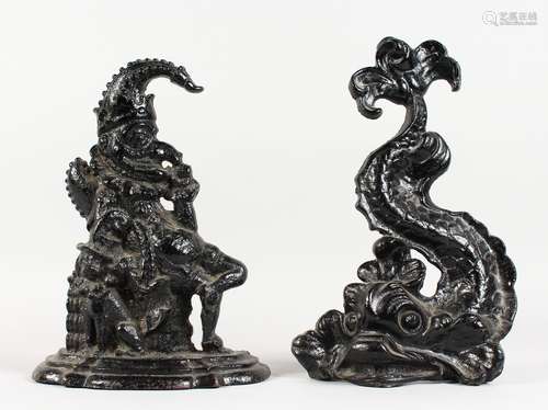 TWO CAST IRON DOORSTOPS, Mr Punch and a classical dolphin. 12.5ins and 13.5ins high.