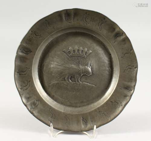 AN UNUSUAL PEWTER CIRCULAR DISH, the border with dolphins. 9.5ins diameter.