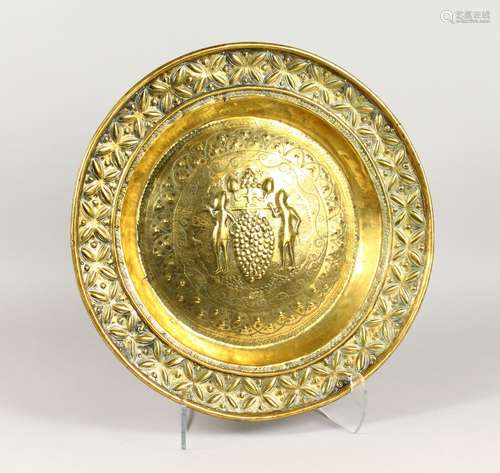 A 19TH CENTURY EMBOSSED BRASS ALMS DISH, 