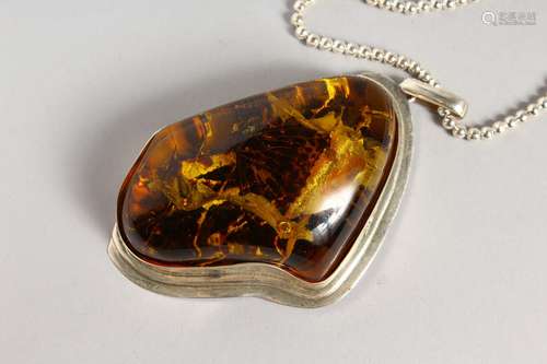 A LARGE PENDANT on a chain. Butterfly in simulation amber.