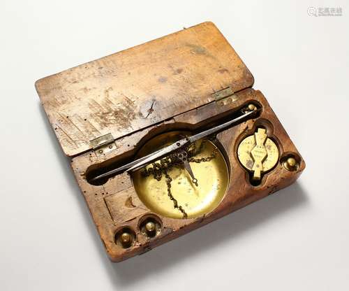 A 19TH CENTURY WALNUT SIDED SET OF SCALES AND WEIGHTS. 8.5ins wide.