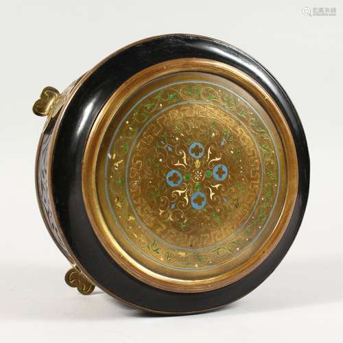 A 19TH CENTURY FRENCH EBONY AND BRASS CIRCULAR BOX, the hinged cover inlaid with enamel, on four