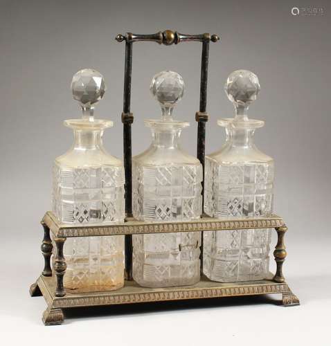 A GOOD THREE BOTTLE CUT GLASS TANTALUS, with three whisky decanters and stoppers.