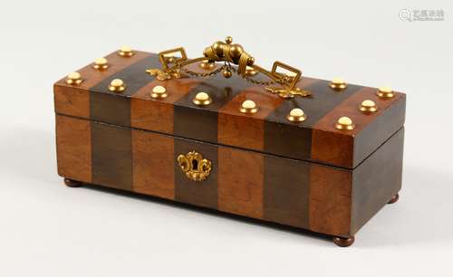 A 19TH CENTURY FRENCH WALNUT AND EBONY BANDED BOX, with ornate ormolu handle and studded decoration.