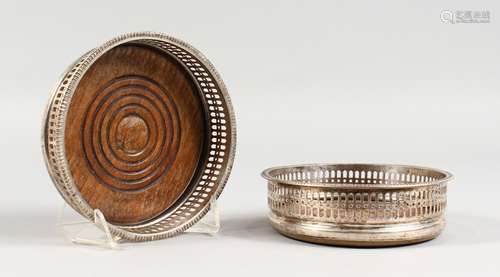 A PAIR OF PLATED CIRCULAR WINE BOTTLE/DECANTER COASTERS, with pierced sided. 5.25ins diameter.