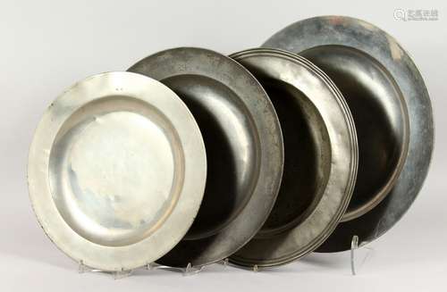 FOUR PEWTER CHARGERS, one marked Thomas King 1675. Largest: 18ins diameter.