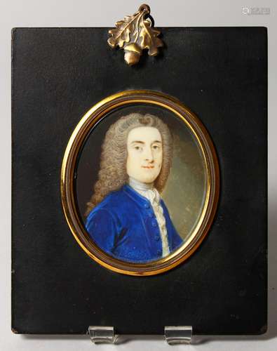 A GEORGE III OVAL PORTRAIT MINIATURE OF A GENTLEMAN, wearing a wig and blue coat, monogrammed B.L.or