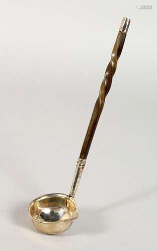 A SILVER TODDY LADLE, with twisted horn handle. Dublin 1820. Maker: PG. 7ins long.