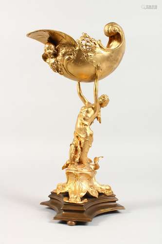 A GILT BRONZE FIGURE OF A MERMAID, holding aloft a shell, on a shaped base. 16ins high.