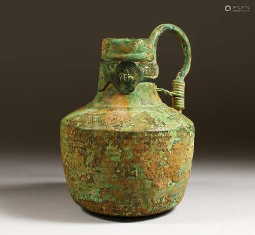 A BYZANTINE BRONZE FLASK with three sheet metal medallions decorating the neck. 8ins high.