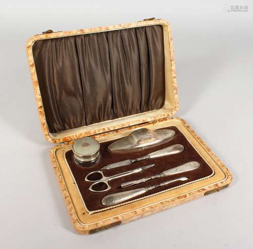 A SILVER MANICURE SET, with engine turned decoration, cased. Birmingham 1928-1930.