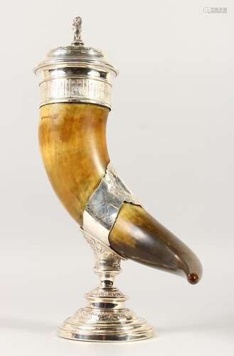 AN IMPRESSIVE HORN CUP, with ornate mounts, the cover with a lion finial. 18ins high.