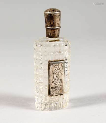 A SILVER MOUNTED CUT GLASS PERFUME BOTTLE. 3.5ins high.