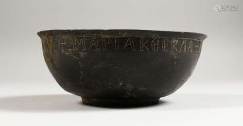 A BYZANTINE BRONZE BOWL, the rim with incised inscription. 7ins diameter.