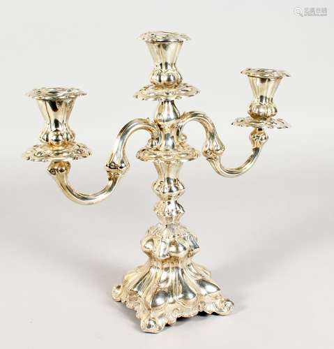 A CONTINENTAL SILVER TWO BRANCH CANDLESTICK, with loaded bases. 12ins high.