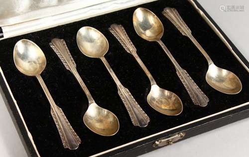 A SET OF SIX TEASPOONS, in a fitted case, stamped silver.