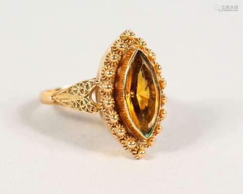 A 9CT GOLD CITRINE MARQUISE RING.