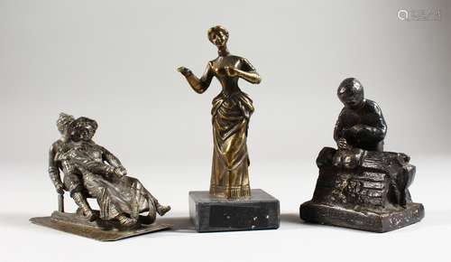 THREE SMALL CAST METAL GROUPS; a couple on a sledge, a clog maker and a standing female.