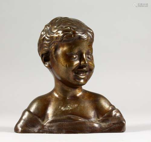 A SMALL BRONZE BUST OF A LAUGHING BOY. 6ins high.