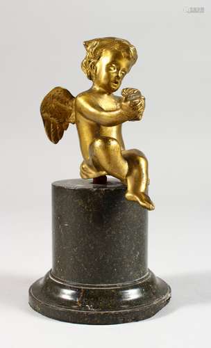 A GILT BRONZE CHERUB, on a circular marble base. 6ins high.