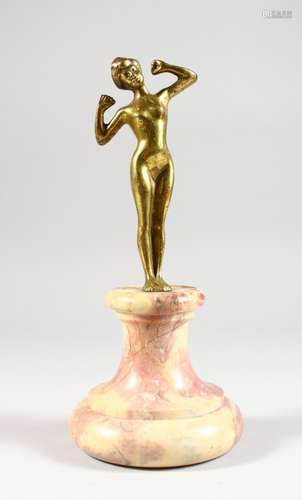 AN ART NOUVEAU SMALL GILT BRONZE FIGURE OF A FEMALE STANDING NUDE, on a marble base. 9.5ins high.