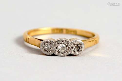 AN 18CT GOLD THREE STONE DIAMOND RING.