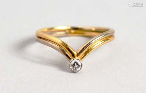 AN 18CT GOLD DIAMOND SET WISHBONE RING.