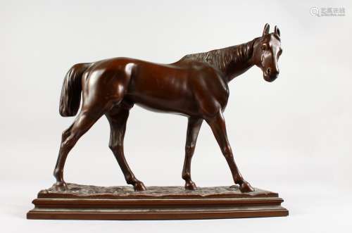 A GOOD LARGE BRONZE STANDING STALLION, on a naturalistic rectangular base. 13ins long x 11ins high.