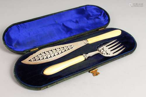 A PAIR OF SILVER CASED FISH SERVERS, with ivory handles. Sheffield 1868.