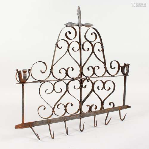 A WROUGHT IRON RACK, with candle holders and hooks. 16.5ins wide.