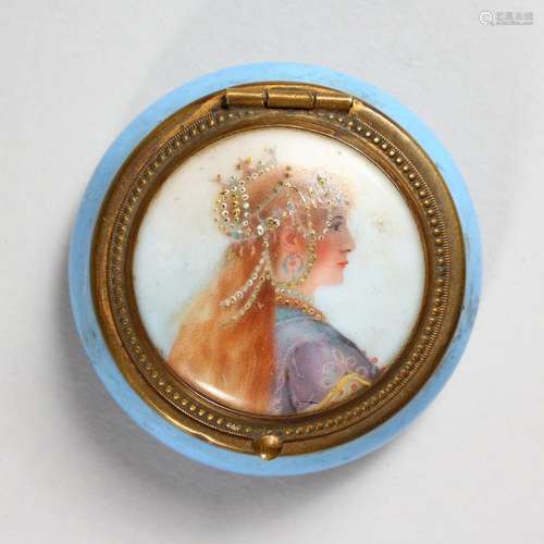 A SMALL CIRCULAR PORCELAIN AND METAL MOUNTED BOX, the hinged lid painted with a portrait of a