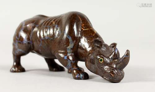 A POSSIBLY FABERGE CARVED HARDSTONE RHINOCEROS, head pointing downwards, with emerald eyes. 4.