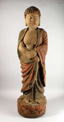 A LARGE CARVED AND PAINTED MODEL OF A STANDING BUDDHA.