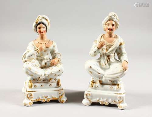 A PAIR OF 19TH CENTURY PORCELAIN INCENSE HOLDERS, modelled as seated male and female Turkish