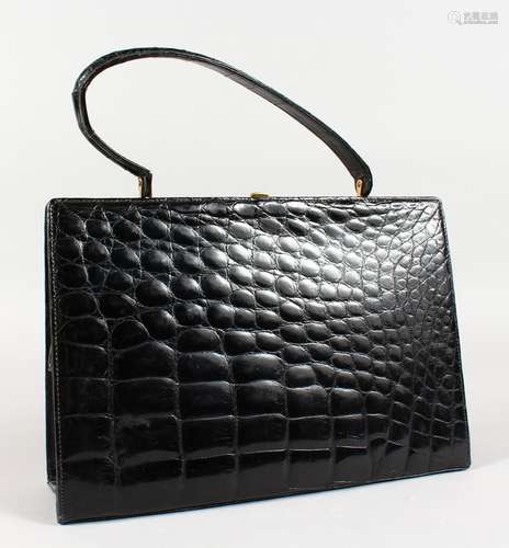 A BLACK CROCODILE SKIN HANDBAG, 11ins.