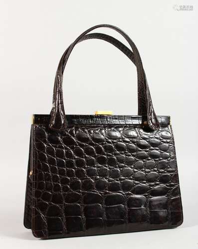 A BLACK CROCODILE SKIN HANDBAG, 10ins.