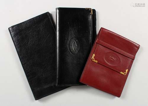 A CARTIER BLACK LEATHER WALLET and A RED WALLET, and another (3).