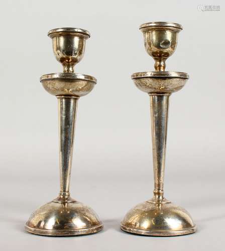 A PAIR OF CIRCULAR SILVER CANDLESTICKS, with loaded bases. Birmingham 1922. 8ins high.