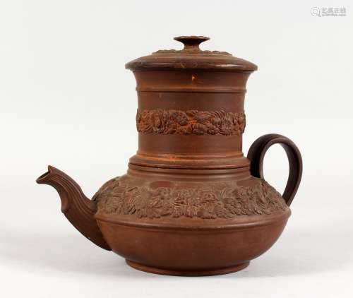 A BROWN GLAZED TERRACOTTA TEAPOT, with filter and moulded decoration. 7.5ins high.