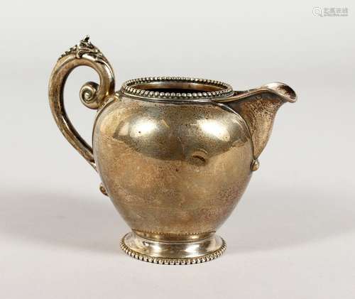 A CONTINENTAL SILVER CREAM JUG. 3.5ins high.