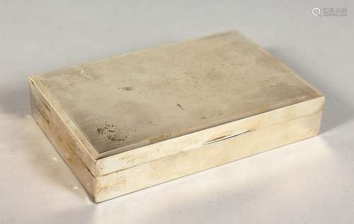 A RECTANGULAR SILVER CIGARETTE BOX, with engine turned decoration. Birmingham 1986. 6.25ins long.