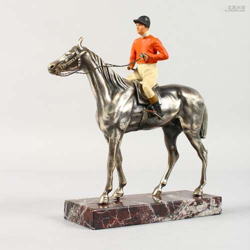 A HORSE AND JOCKEY on a marble base. 8ins high.