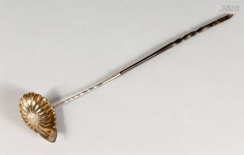 A CONTINENTAL SILVER TODDY LADLE, with shell shape bowl and twisted horn handle. 16.5ins long.