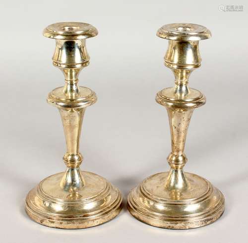 A PAIR OF CIRCULAR SILVER CANDLESTICKS. Stamped Argentina 925, 32ozs, weighted bases. 8.5ins high.